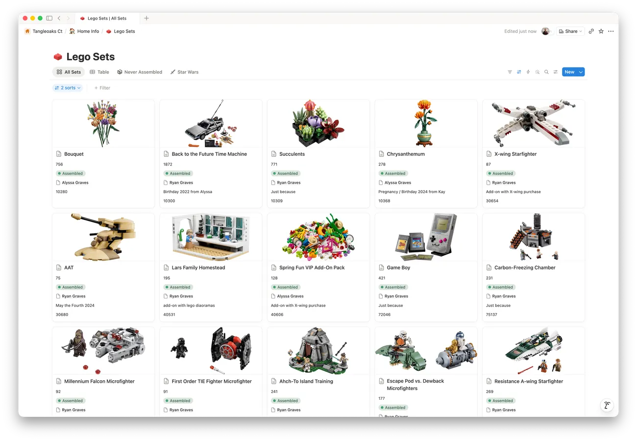 A Notion database in gallery view, with tabs for different views, sort and filter controls, and a grid of cards. Each card has an official set photo, the set name, piece count, a status tag, an owner, an occasion note, and a set number.